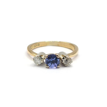 18ct yellow gold ring with 0.40ct tanzanite centerpiece and 0.20ct diamond accents, elegant jewelry with vibrant gemstones.
