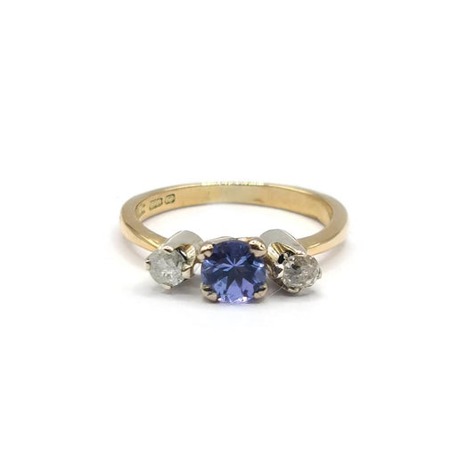 18ct yellow gold ring with 0.40ct tanzanite centerpiece and 0.20ct diamond accents, elegant jewelry with vibrant gemstones.