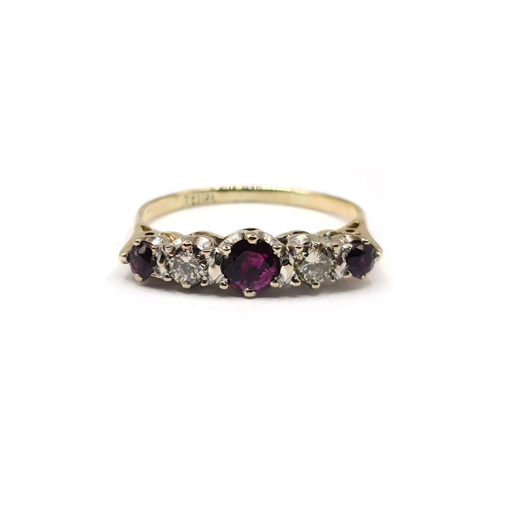 18ct yellow gold ring with a 0.85 carat ruby and 0.44 carat diamond accents, elegant jewelry design.