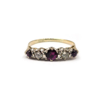 18ct yellow gold ring with a 0.85 carat ruby and 0.44 carat diamond accents, elegant jewelry design.