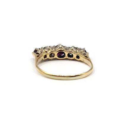 18ct yellow gold ring with 0.85 carat ruby and 0.44 carat diamond accents, showcasing elegant jewelry design.