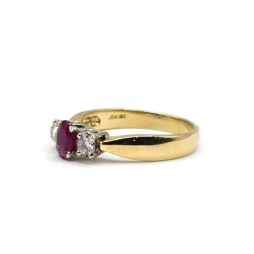 18ct yellow gold ring featuring a 1/2 carat ruby and 0.30 carat diamond accents, elegant jewelry piece with a classic design.