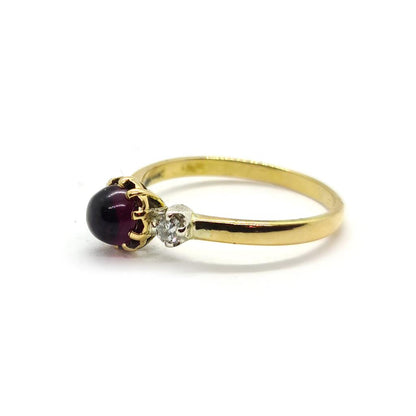 18ct yellow gold ring featuring a 1.45 carat garnet and 0.30 carat diamond accents, elegant jewelry piece.
