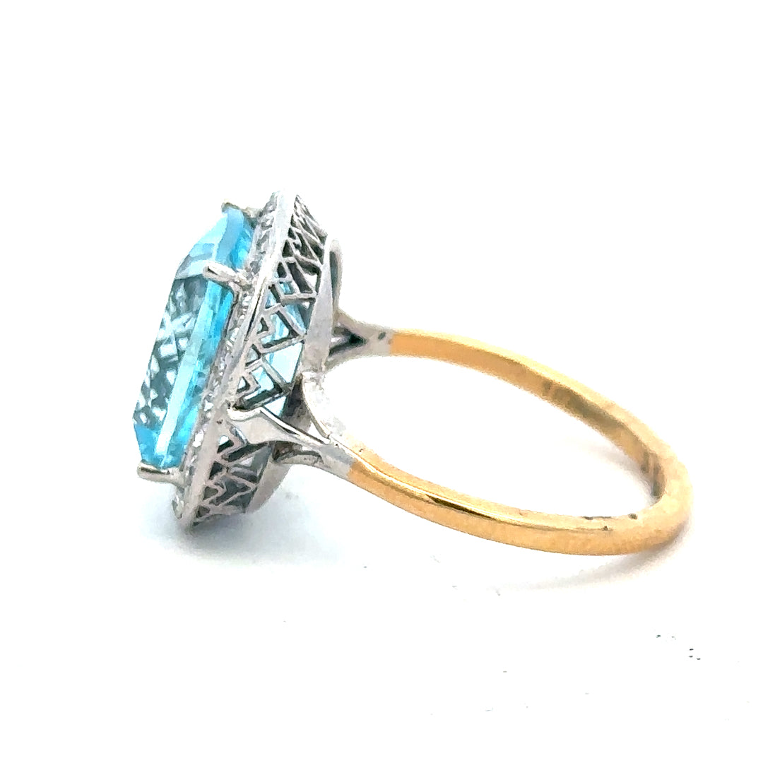 18ct yellow gold ring with a 10.70 carat topaz and 0.40 carat diamonds, size R, showcasing a luxurious gemstone design.