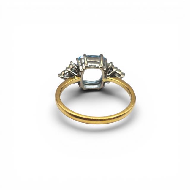 18ct yellow gold aquamarine and diamond ring with a central aquamarine gemstone and diamond accents, elegant jewelry piece.