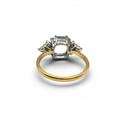 18ct yellow gold aquamarine and diamond ring with a central aquamarine gemstone and diamond accents, elegant jewelry piece.