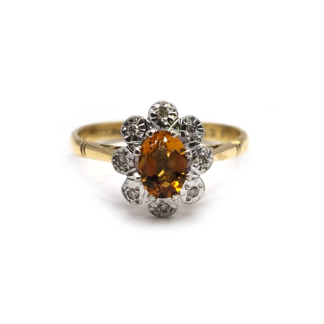 18ct yellow gold citrine and diamond ring with a polished band, showcasing a vibrant citrine gemstone and sparkling diamonds.