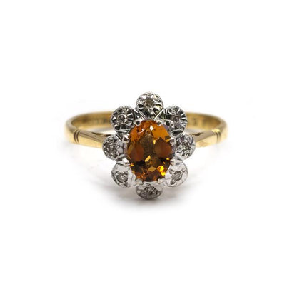 18ct yellow gold citrine and diamond ring with a polished band, showcasing a vibrant citrine gemstone and sparkling diamonds.
