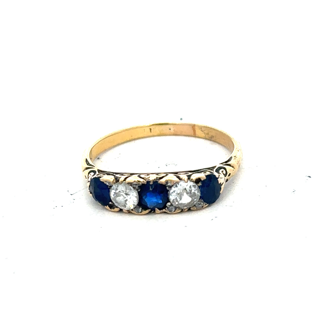 18ct yellow gold diamond and sapphire ring in size O 1/2, featuring sparkling gemstones and a polished band.