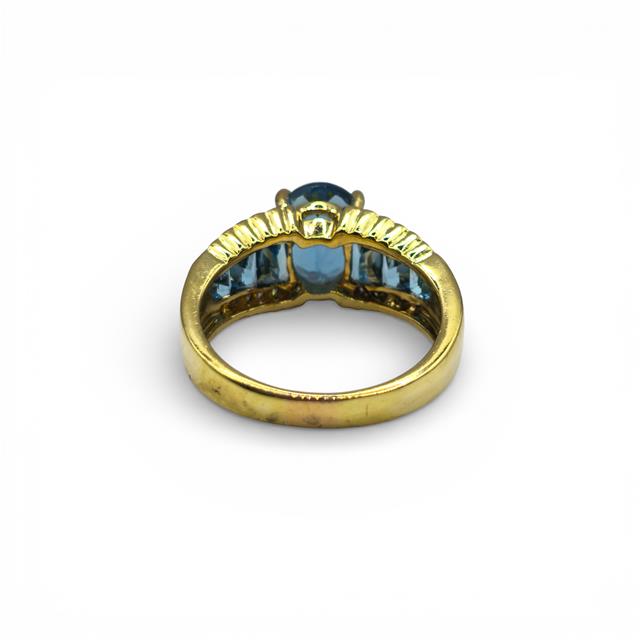 18ct yellow gold ring with sparkling diamonds and vibrant topaz, featuring a sleek design and elegant craftsmanship.