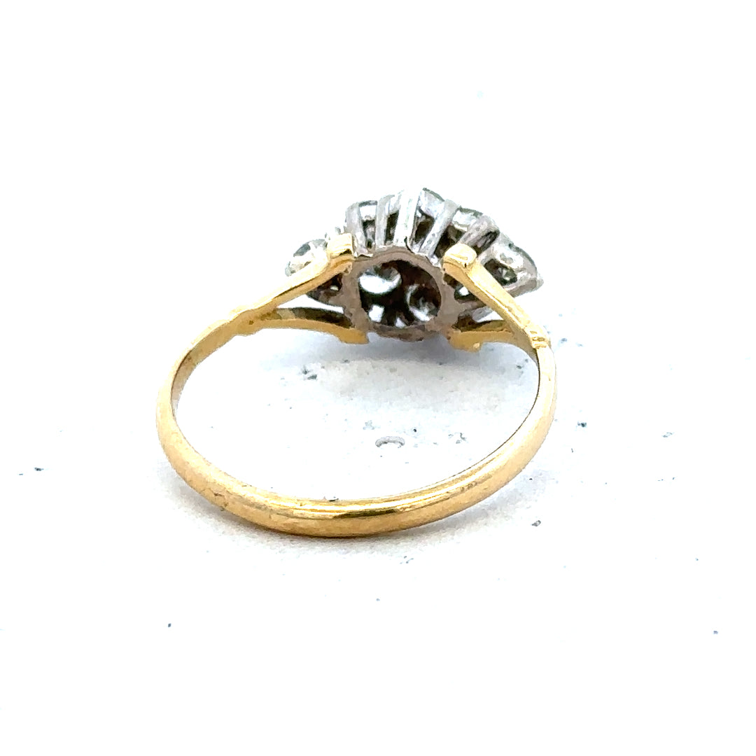 18ct yellow gold diamond cluster ring featuring a sparkling central design and intricate gold detailing.
