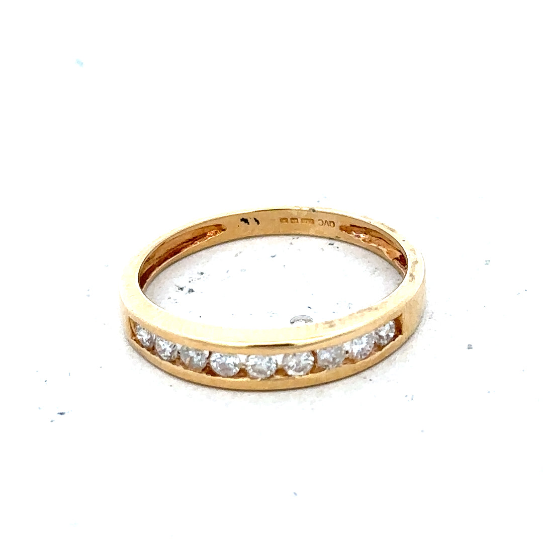18ct yellow gold diamond half eternity ring with sparkling diamonds set around the band, showcasing elegant jewelry craftsmanship.