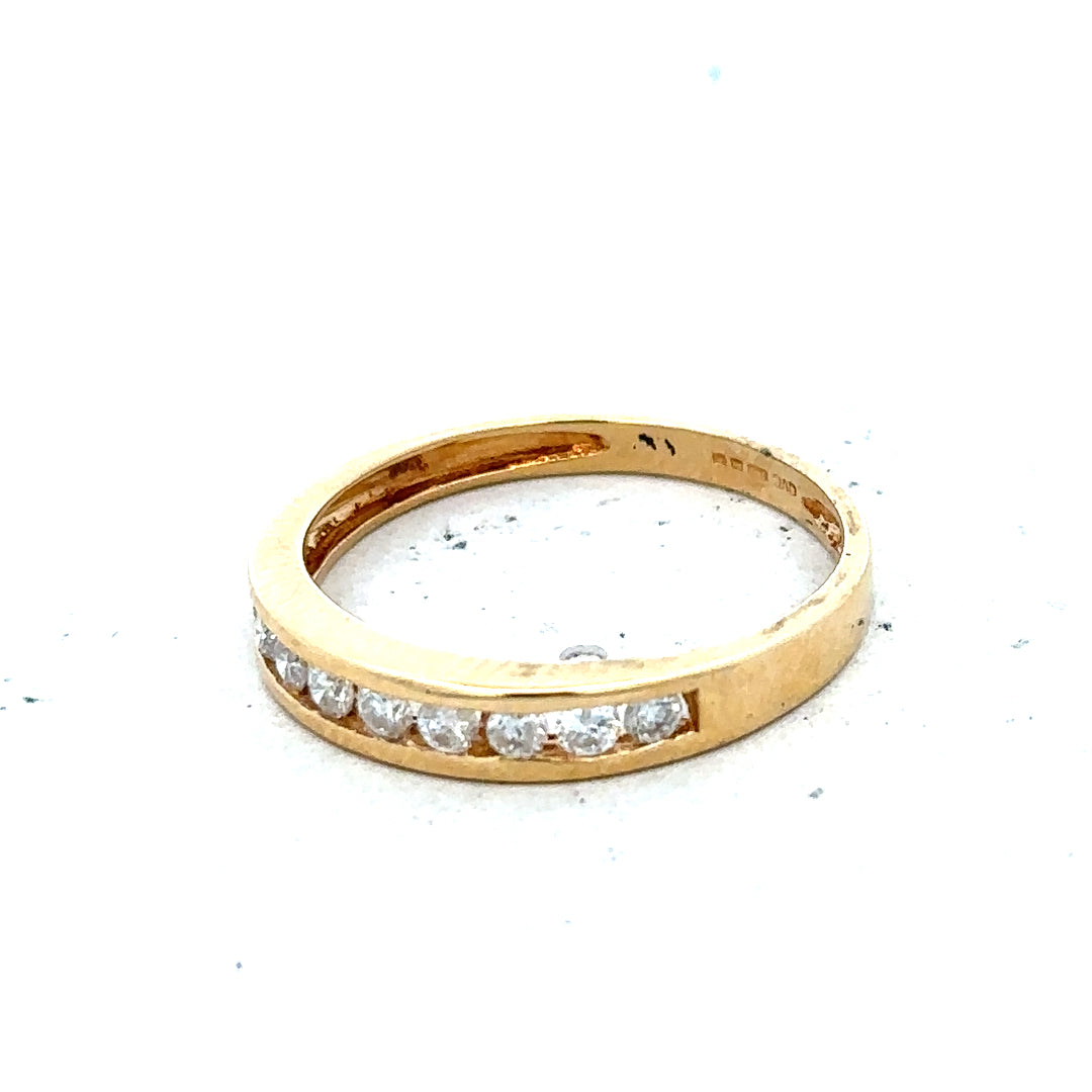 18ct yellow gold diamond half eternity ring with a continuous row of sparkling diamonds on a sleek band