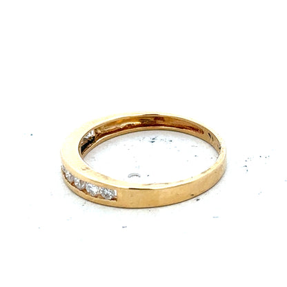 18ct yellow gold diamond half eternity ring with sparkling diamonds and a sleek band design.