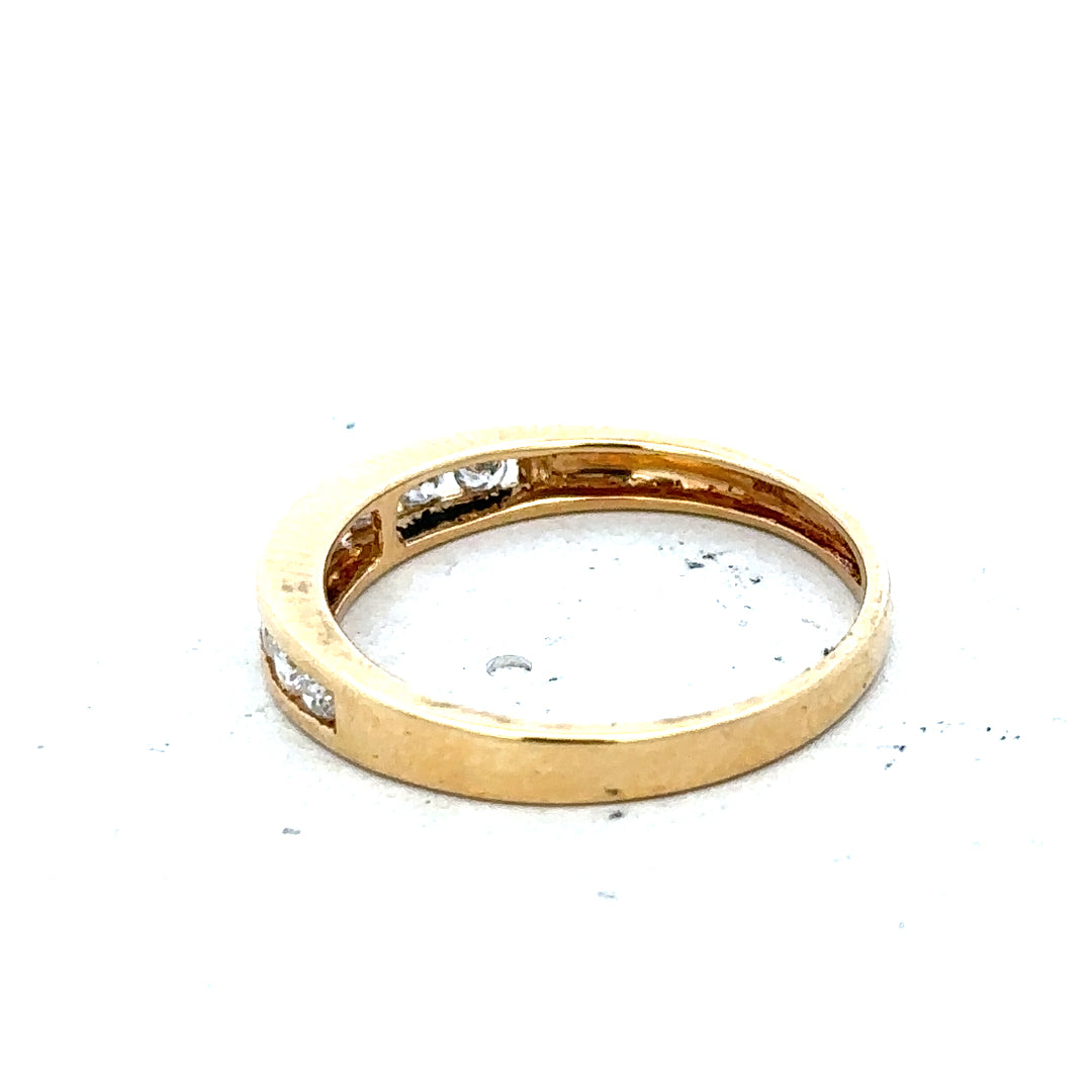 18ct yellow gold diamond half eternity ring with a row of sparkling diamonds encircling the band.