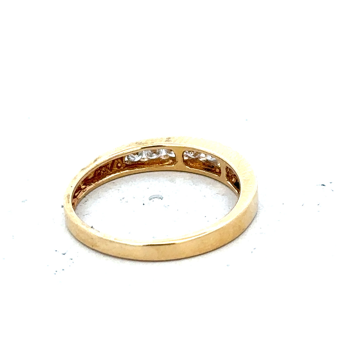18ct yellow gold diamond half eternity ring with a row of sparkling diamonds around the band.