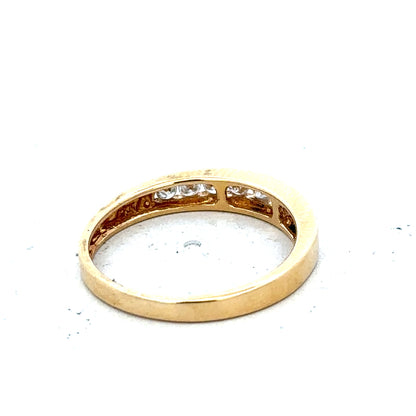 18ct yellow gold diamond half eternity ring with a row of sparkling diamonds around the band.