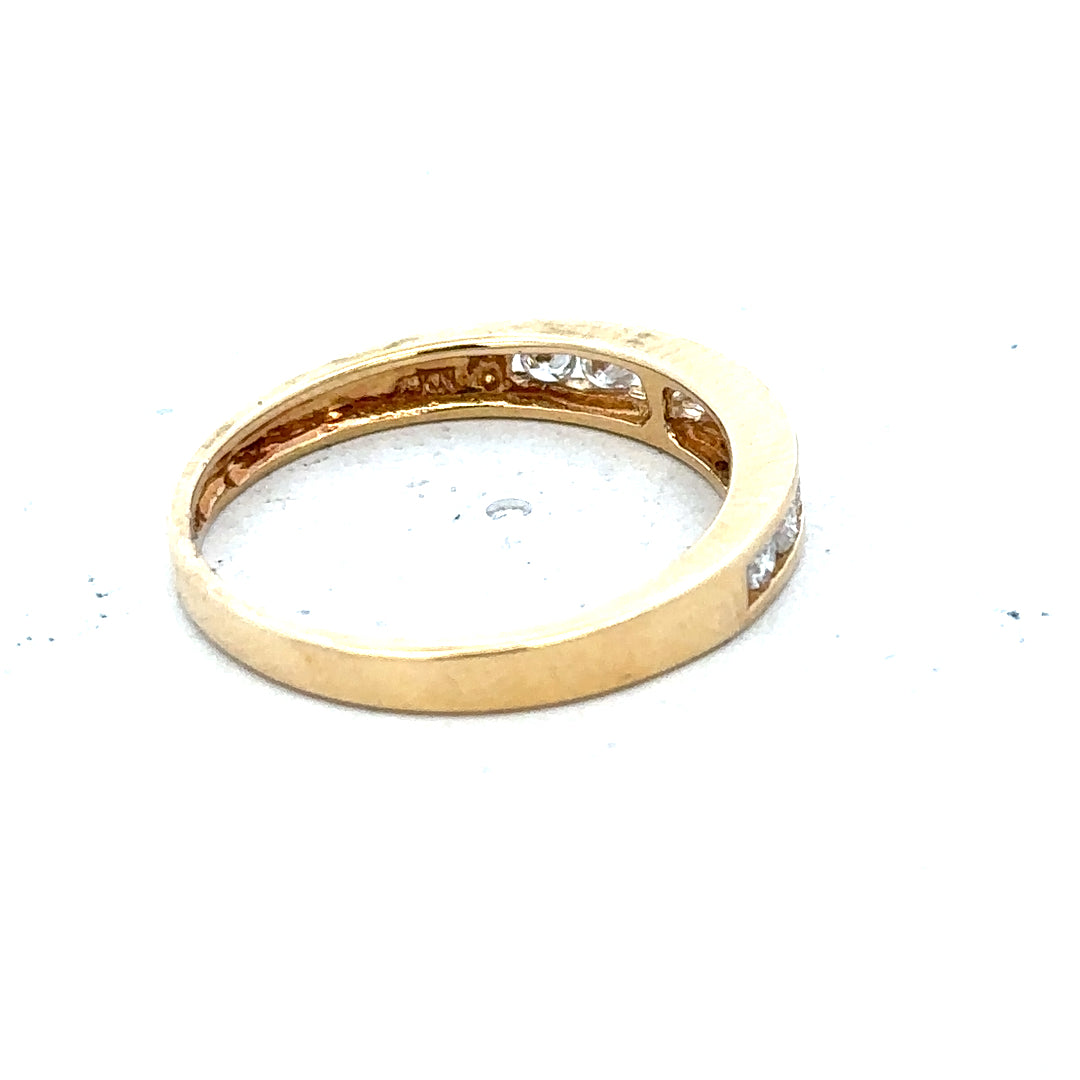 18ct yellow gold diamond half eternity ring with a row of sparkling diamonds encircling the band.
