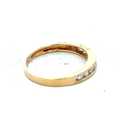 18ct yellow gold diamond half eternity ring with a row of sparkling diamonds set in a sleek band.