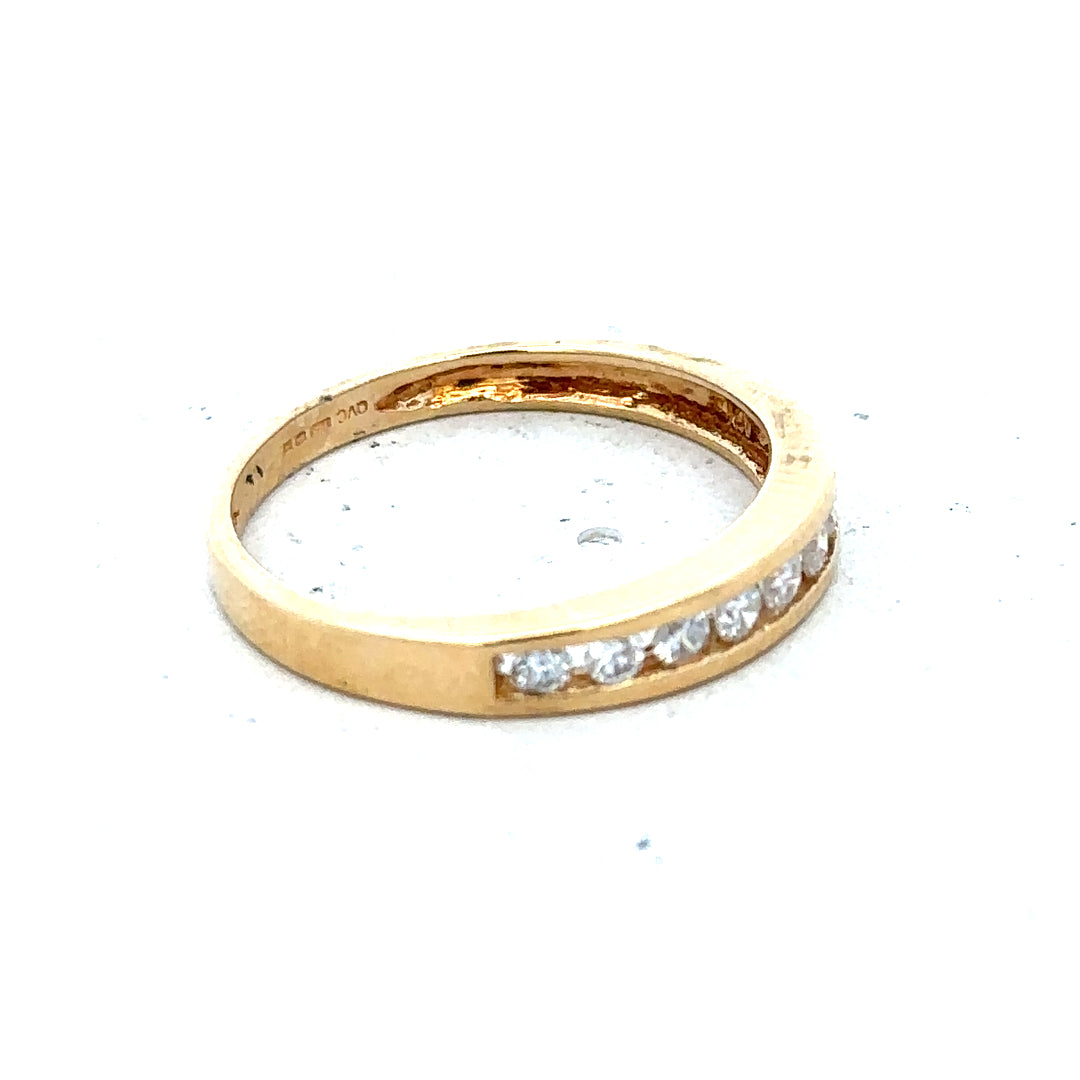 18ct yellow gold diamond half eternity ring with sparkling round diamonds, showcasing elegant design and fine craftsmanship.