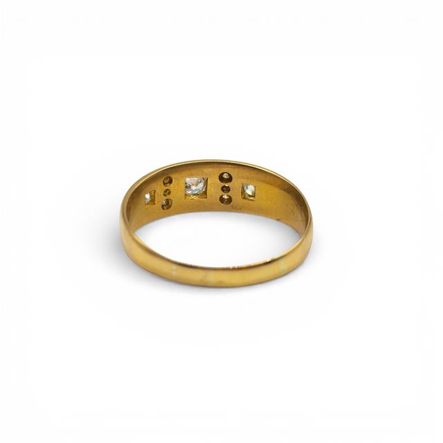 18ct yellow gold diamond ring with sparkling central diamond, showcasing elegant craftsmanship and classic jewelry design.