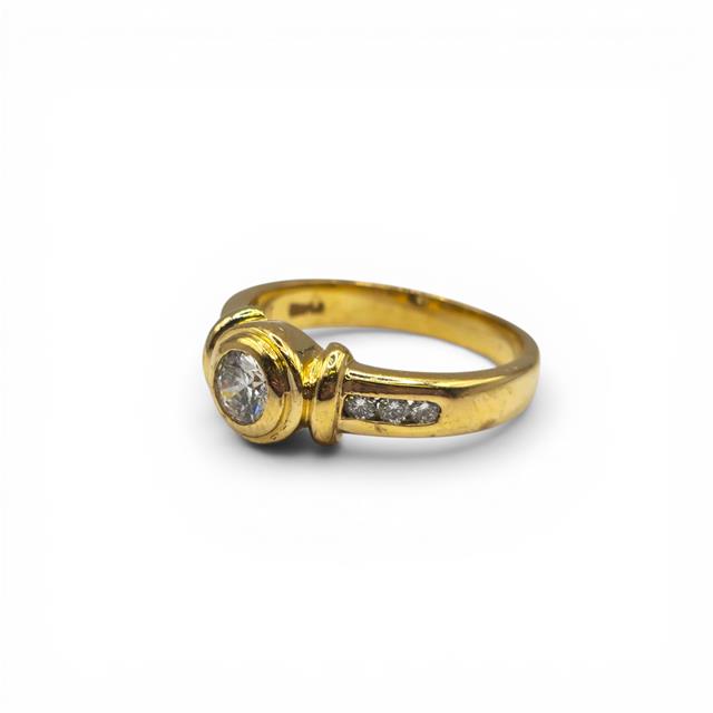 18ct yellow gold diamond ring with a central diamond, crafted in elegant design, from an unbranded jewelry collection.