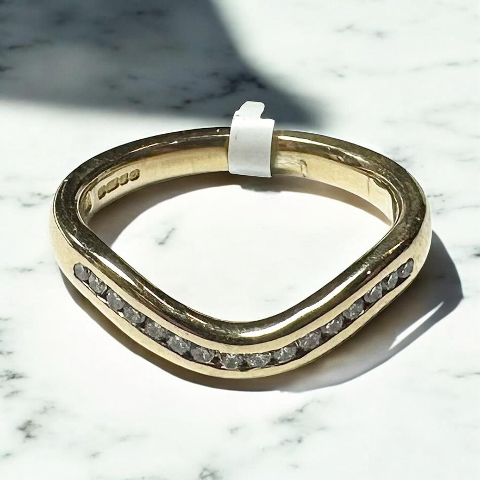 18ct yellow gold diamond ring in size K, featuring a sparkling diamond setting and a sleek, polished band.