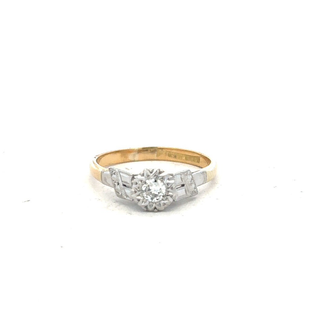 18ct yellow gold diamond ring in size L, featuring a detailed design with sparkling diamonds on a polished gold band.