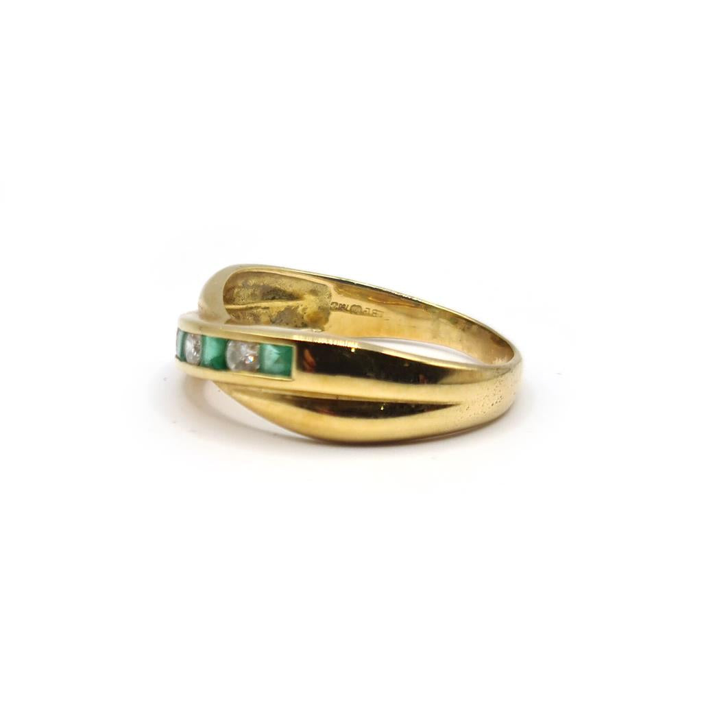 18ct yellow gold emerald and diamond half eternity ring with alternating gemstones and a polished band for elegant jewelry.