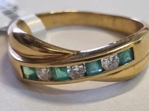 18ct yellow gold emerald and diamond half eternity ring featuring alternating gemstones and a sleek, elegant design.