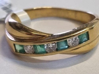 18ct yellow gold emerald and diamond half eternity ring featuring alternating gemstones and a sleek, elegant design.