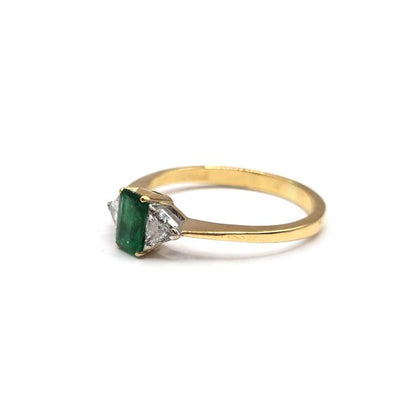 18ct yellow gold emerald and diamond ring with a detailed design, showcasing vibrant green emeralds and sparkling diamonds.