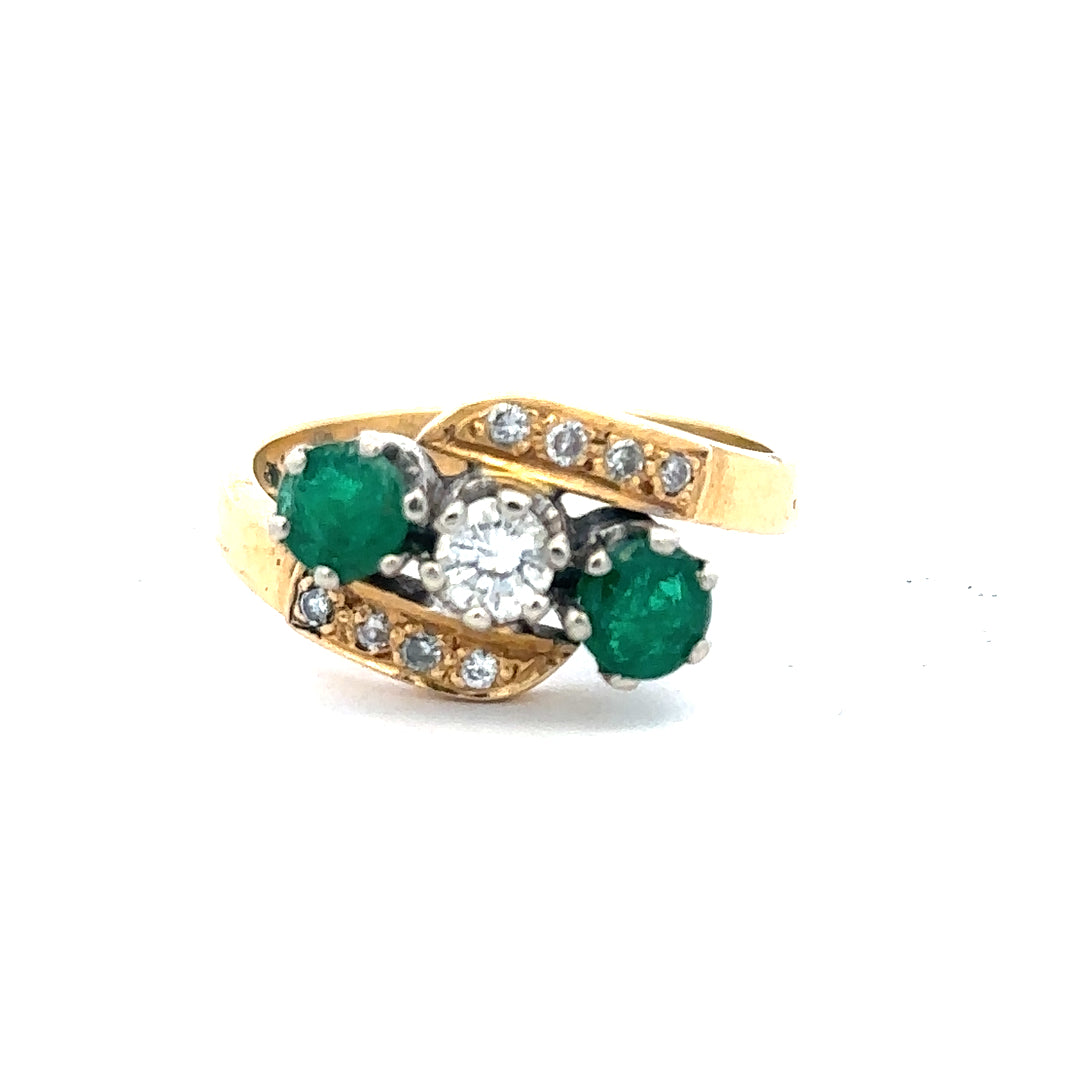 18ct yellow gold emerald and diamond ring, size N, featuring a central emerald stone with sparkling diamonds on the band.