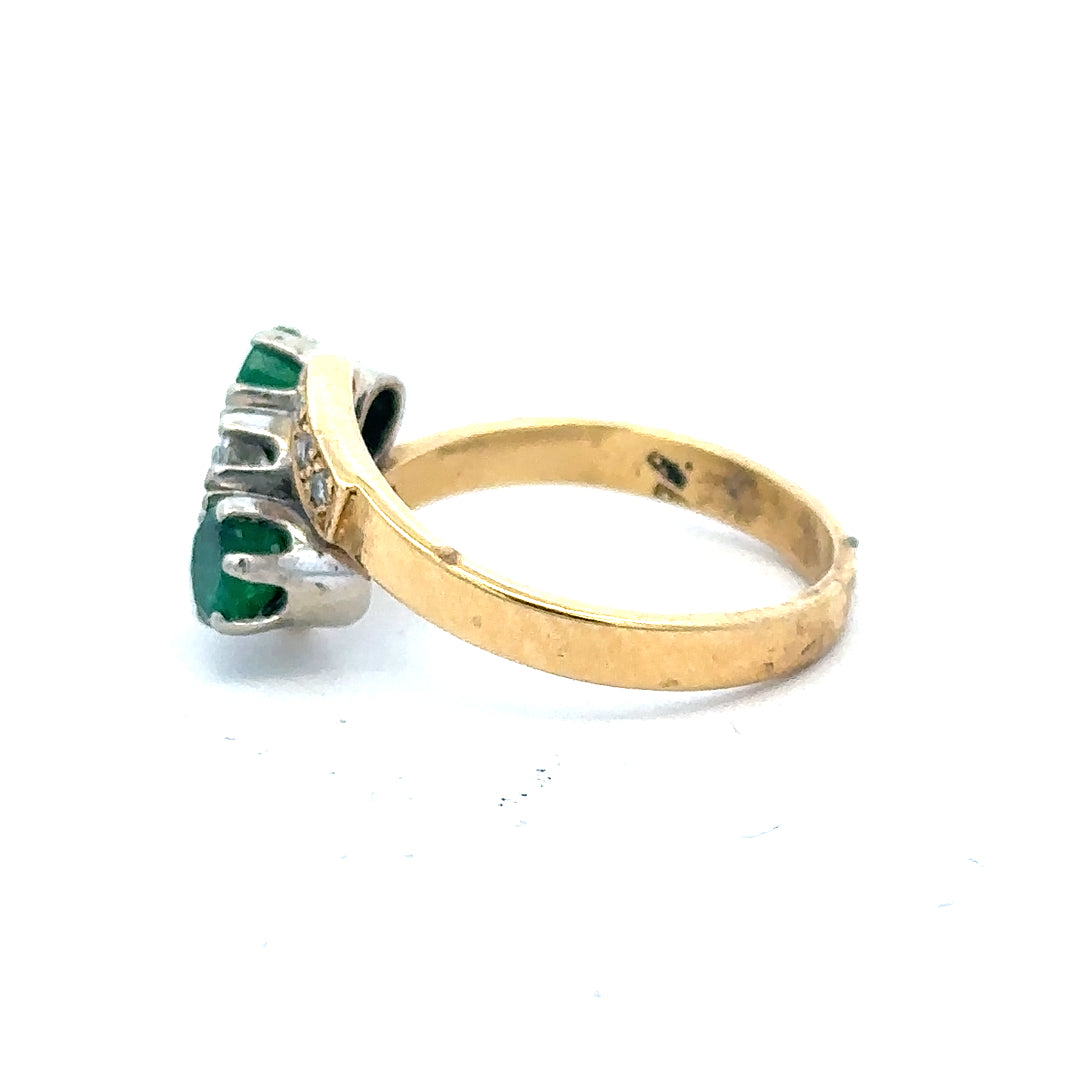 18ct yellow gold emerald and diamond ring in size N, featuring a central emerald with diamond accents.