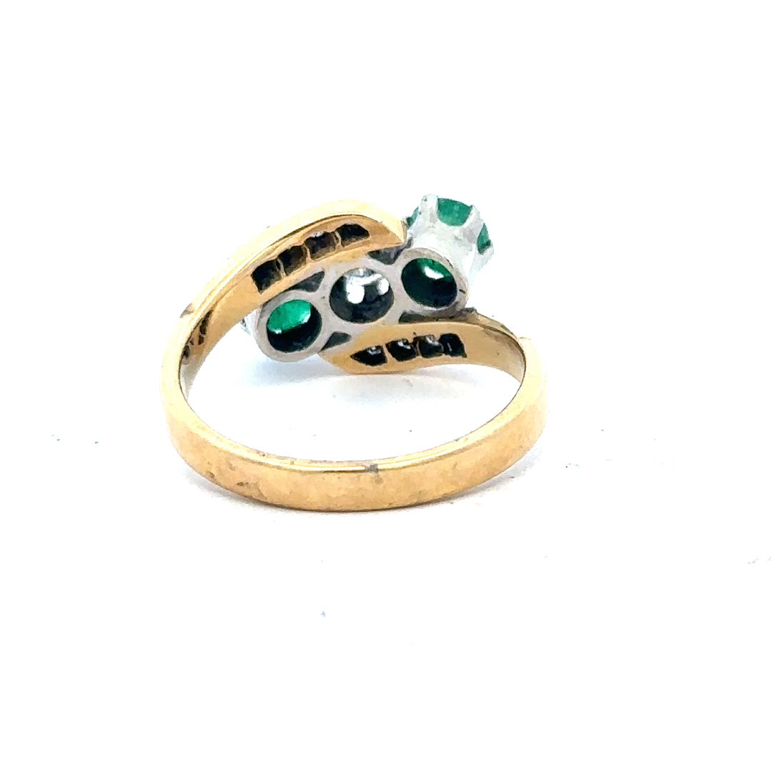 18ct yellow gold emerald and diamond ring in size N, featuring a central emerald with sparkling diamonds on a sleek band.