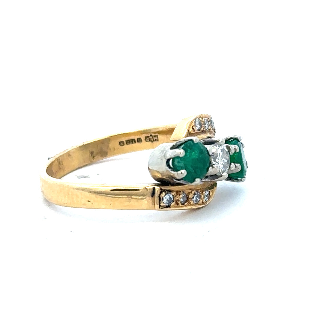 18ct yellow gold emerald and diamond ring in size N, featuring a central emerald surrounded by sparkling diamonds.