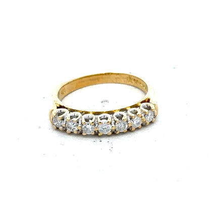 18ct yellow gold half eternity diamond ring with a row of sparkling diamonds, showcasing elegant craftsmanship.