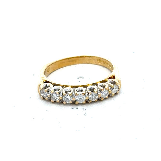 18ct yellow gold half eternity diamond ring with a row of sparkling diamonds, showcasing elegant craftsmanship.