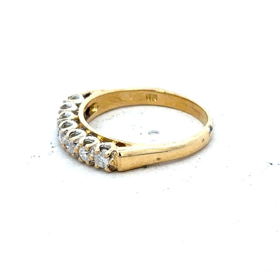 18ct yellow gold half eternity diamond ring with sparkling diamonds encircling the band, elegant and timeless jewelry piece.