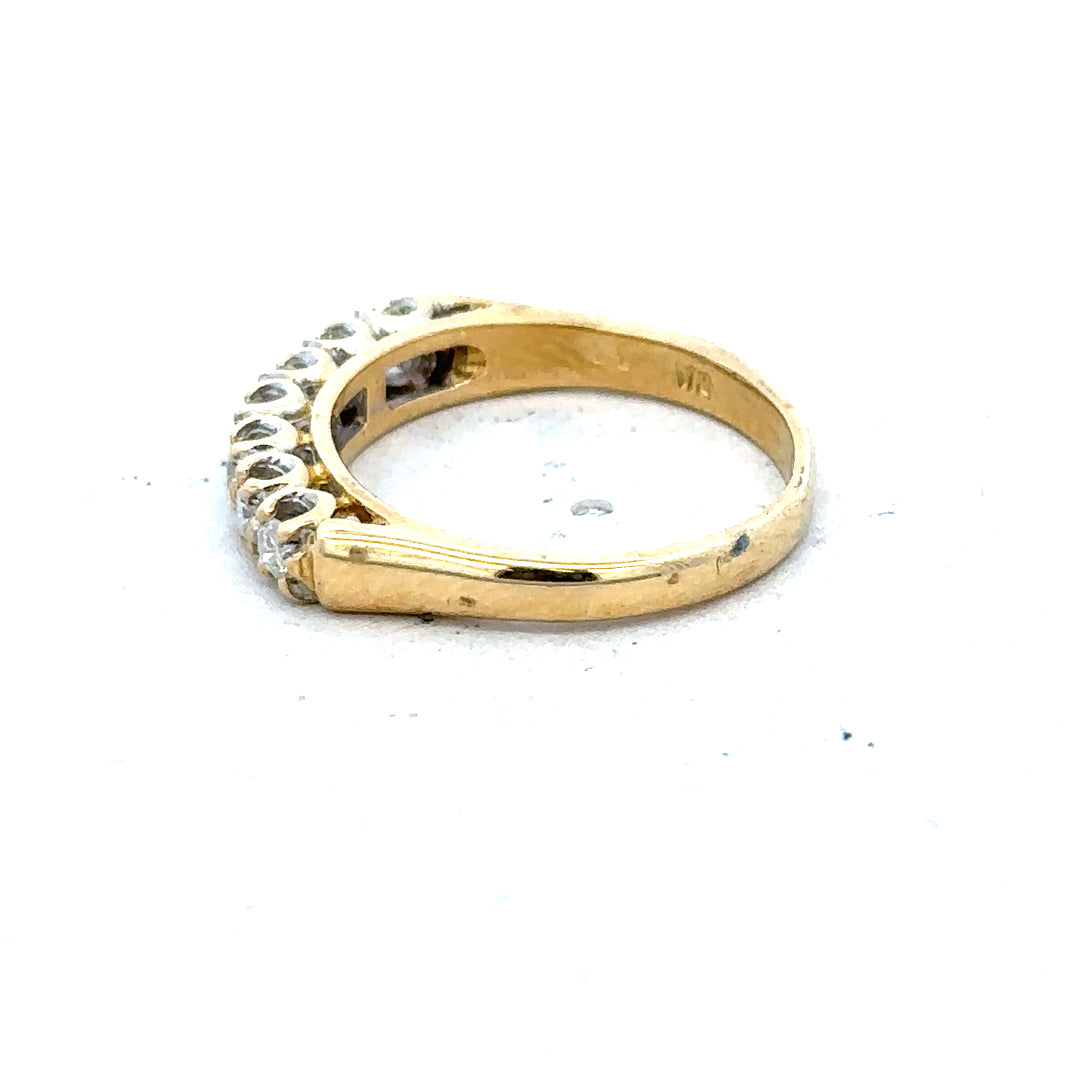 18ct yellow gold half eternity diamond ring with alternating small round diamonds on a sleek band.