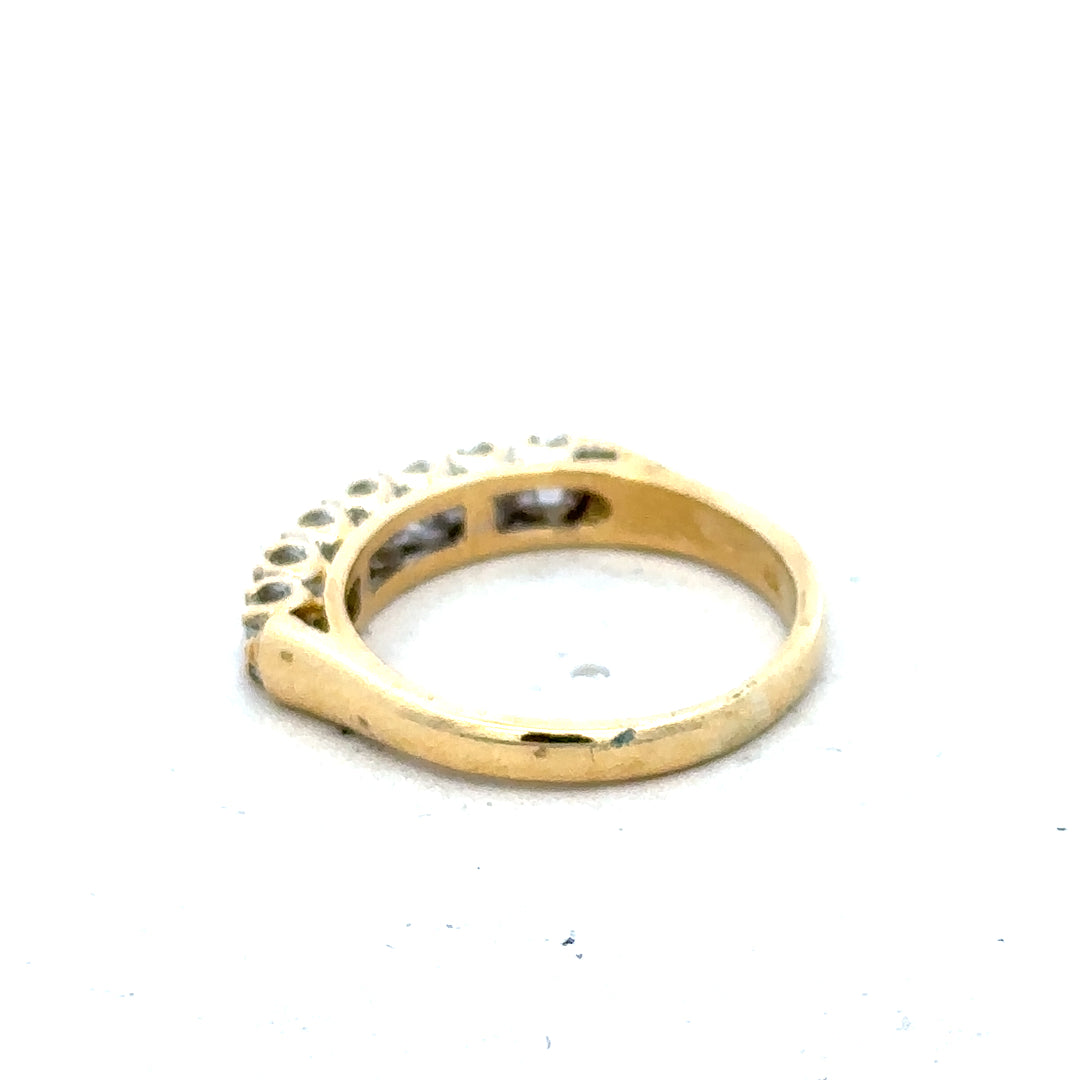 18ct yellow gold half eternity diamond ring with sparkling diamonds set around the band, showcasing elegant jewelry design.