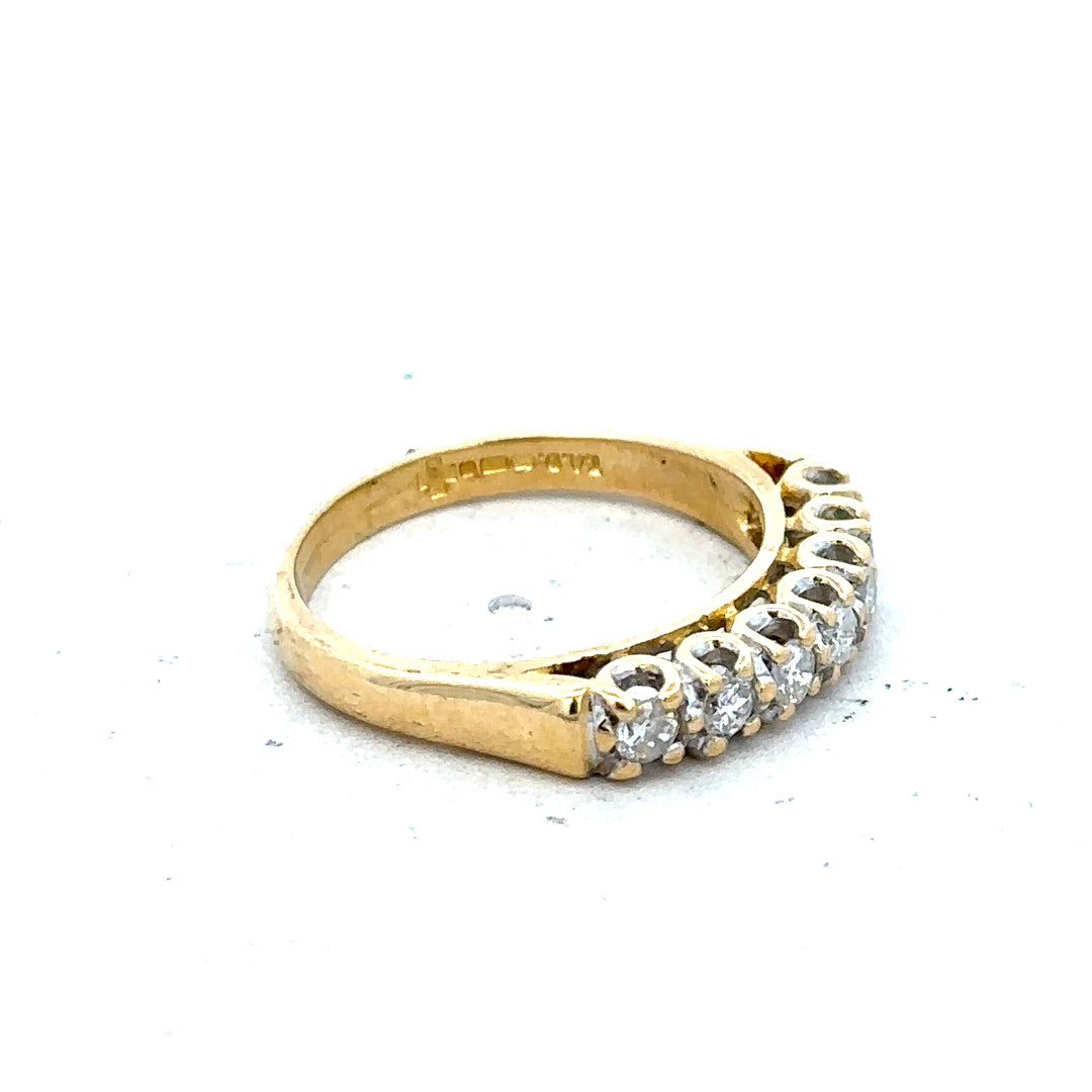 18ct yellow gold half eternity diamond ring with alternating small diamonds around the band, elegant and sparkling jewelry piece.