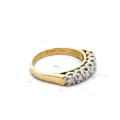 18ct yellow gold half eternity diamond ring with alternating small diamonds around the band, elegant and sparkling jewelry piece.