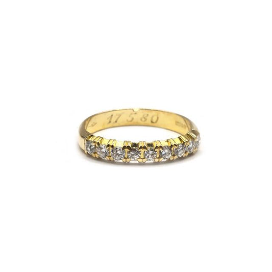 18ct yellow gold half eternity diamond ring with sparkling accent diamonds, showcasing elegant craftsmanship.