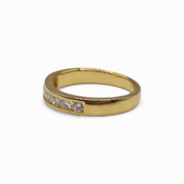 18ct yellow gold half eternity diamond ring with sparkling diamonds, showcasing a luxurious jewelry piece.