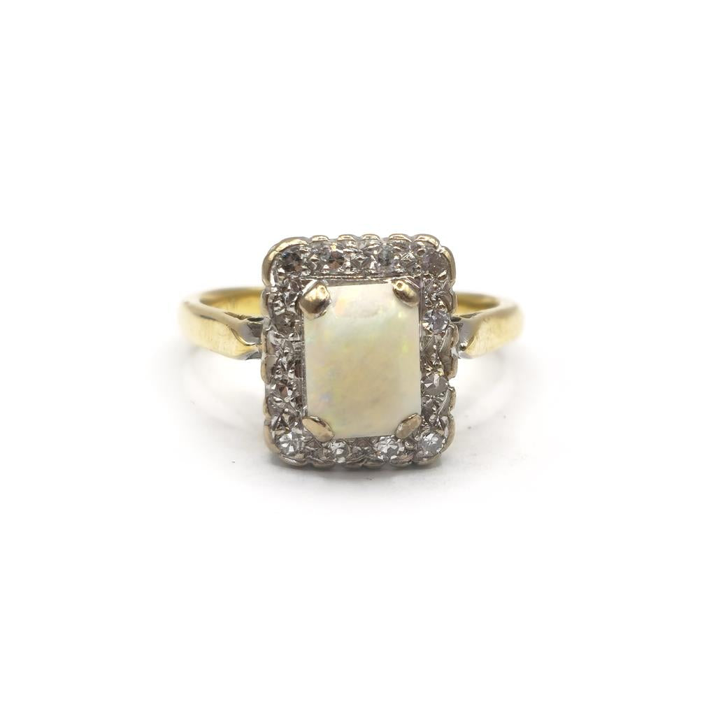 18ct yellow gold opal and diamond ring in size N1/2, featuring an elegant opal centerpiece with diamond accents.