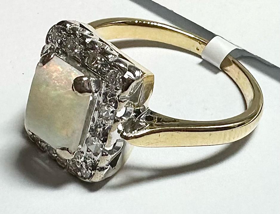 18ct yellow gold opal and diamond ring in size N1/2, featuring a vibrant opal gemstone and sparkling diamonds.