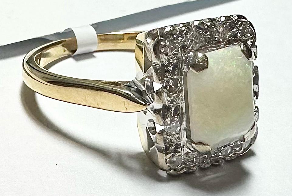 18ct yellow gold opal and diamond ring, size N 1/2, featuring a vibrant opal gemstone and sparkling diamonds.