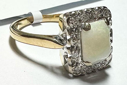 18ct yellow gold opal and diamond ring, size N 1/2, featuring a vibrant opal gemstone and sparkling diamonds.