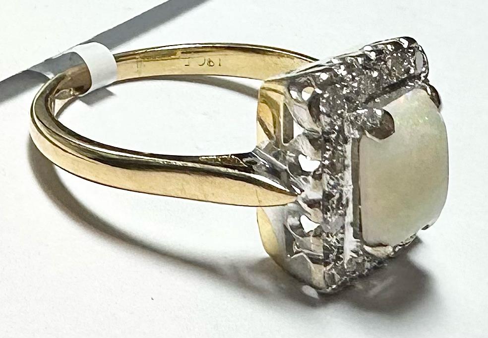 18ct yellow gold opal and diamond ring in size N1/2, featuring a vibrant opal centerpiece with diamond accents.
